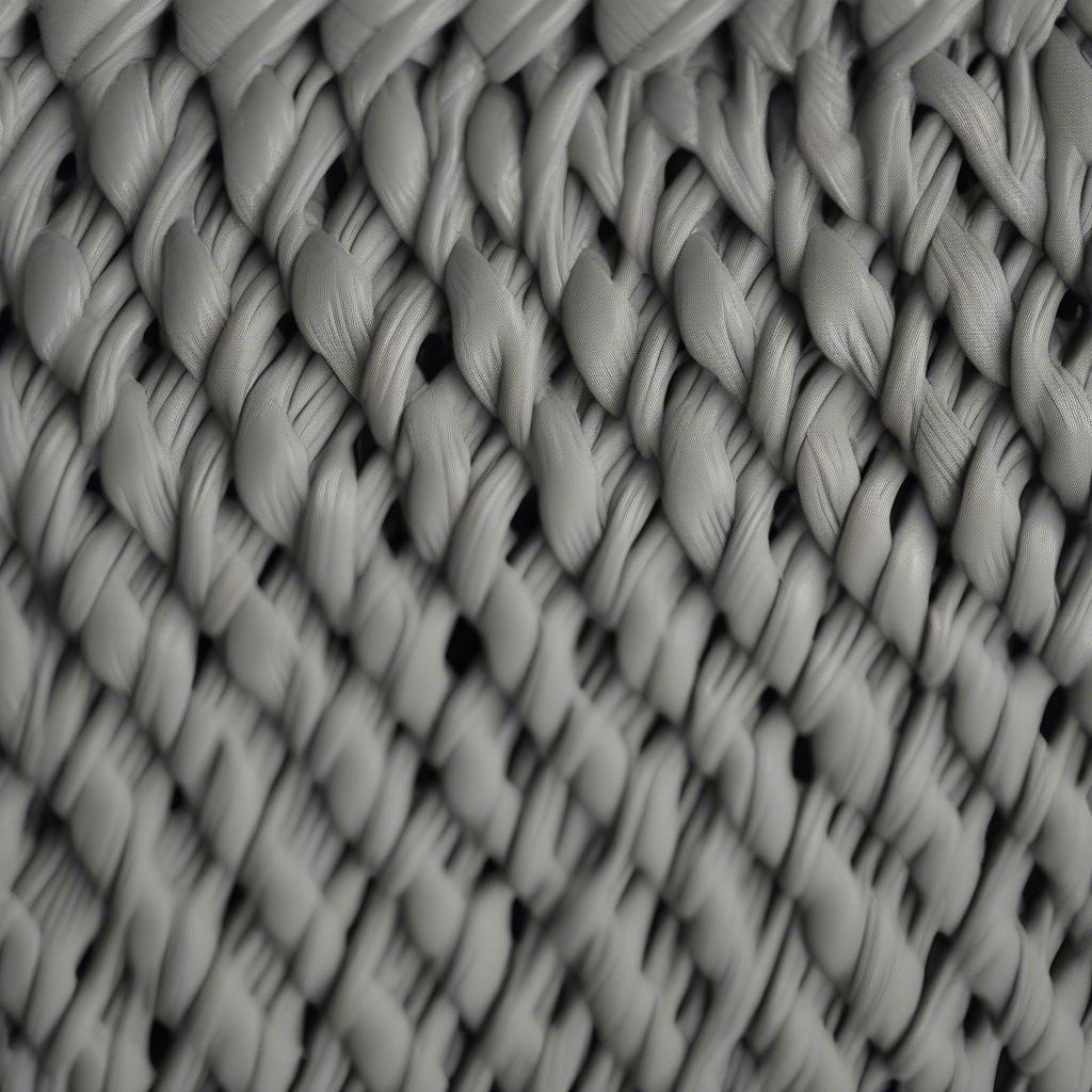 Close-up of a Grey Suncast Resin Wicker Storage Seat