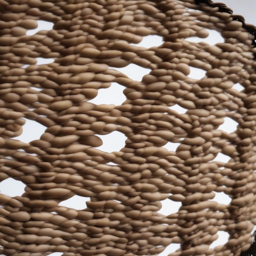 Close-up of a wicker placemat adorned with cowrie shells, showcasing the intricate details and natural beauty of the materials.