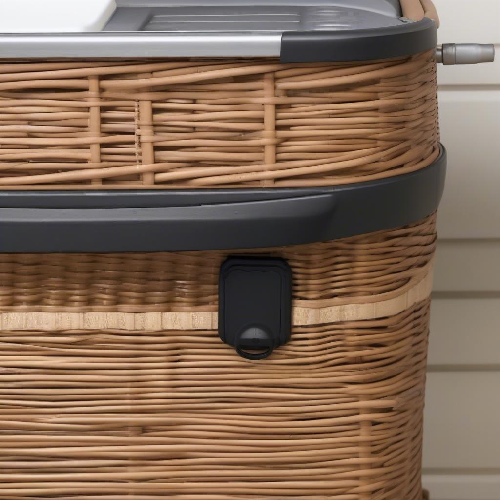 Close-up of wicker storage and prep station features like locking lid, wheels, and removable liner