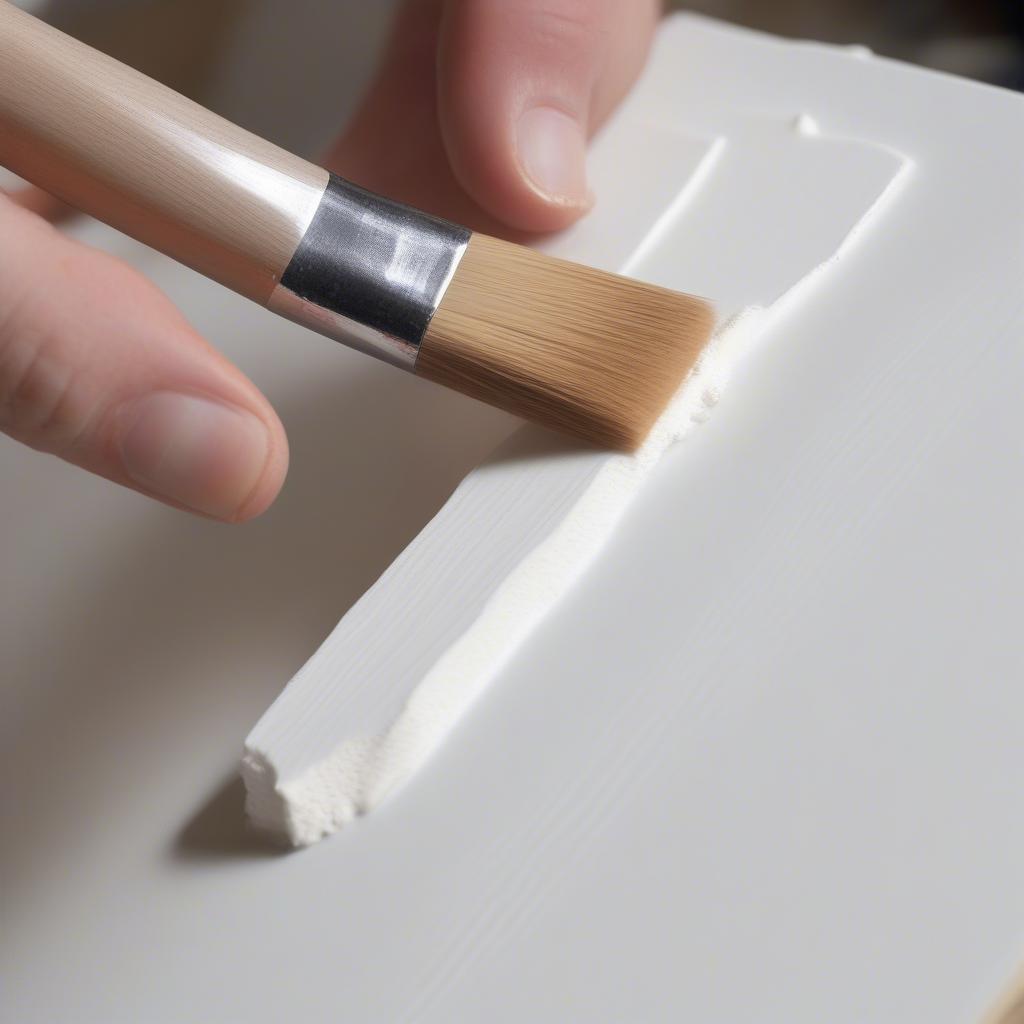 Applying gesso to an 11x14 canvas