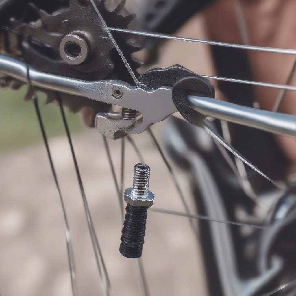 Person using an adjustable wrench multi tool to tighten a bolt on a bicycle