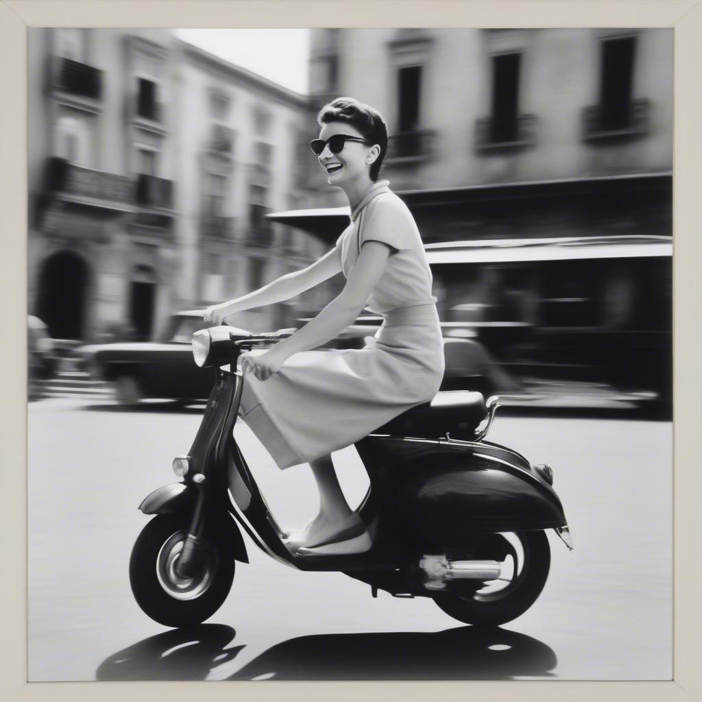 Black and white framed photograph of Audrey Hepburn in Roman Holiday, capturing a candid moment of joy and spontaneity.