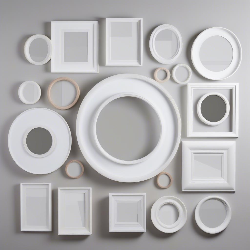 Various sizes of white circle picture frames.