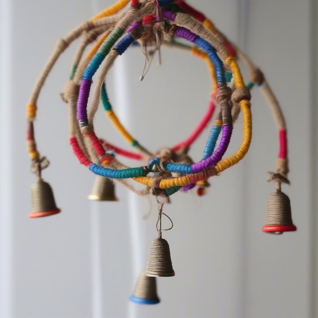 A handmade hanger bell crafted with twine, beads, and small bells.