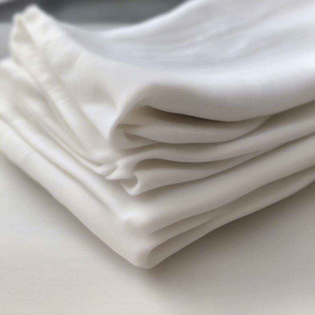 Linen wedding napkins stacked neatly in bulk, showcasing their elegant texture and soft folds.