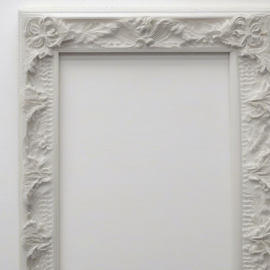 Close-up of an ornate white 24x36 picture frame