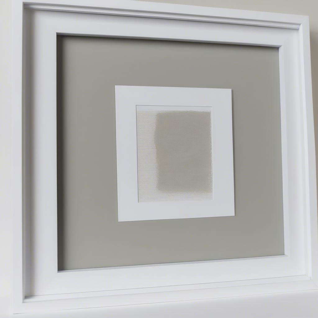 Close-up of a 16x20 white picture frame with mat