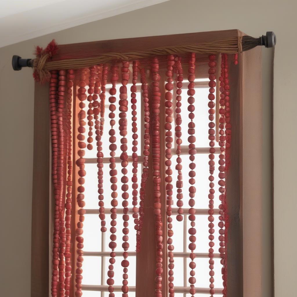 Red wood bead garland used as a curtain tieback in a farmhouse style room.