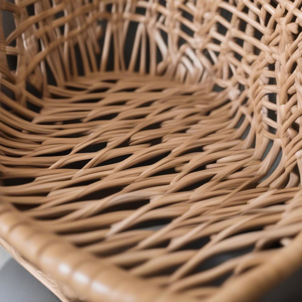 Close-up of a rattan chair designed by Yvonne Smallwood, showcasing intricate weaving and meticulous craftsmanship.